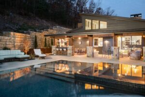 The rear exterior of The Sennett Residence showcasing a stunning infinity pool overlooking the Blue Ridge Mountains.
