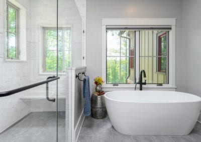 Bath and shower area with large window and view of moutains