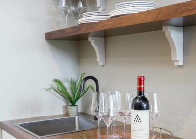 wine station with sink and shelving