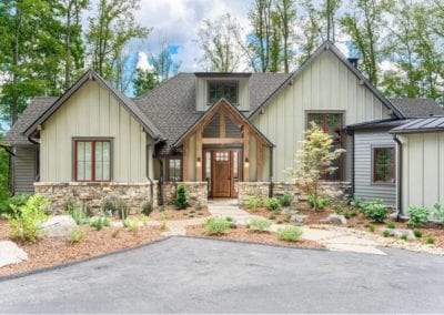 Front of home showing front door and landscaping