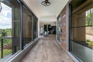 Interior corridor with floor-to-ceiling windows, flooding the space with natural light.