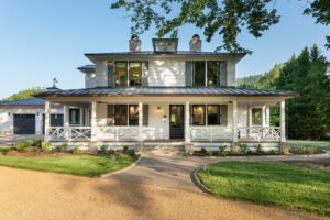 White house front porch, remodeled and energy-efficient, near Asheville, NC, built by luxury home builder, with original farmhouse elements, locally milled wood, exposed beams, and natural elements.