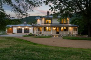 Remodeled energy-efficient house near Asheville, North Carolina, by luxury home builder with original farmhouse aspects, locally milled wood, exposed beams, and natural elements.