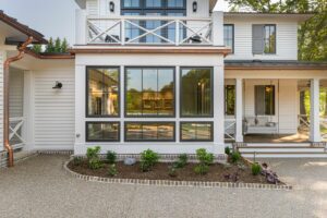 Sun room view of remodeled, energy-efficient luxury home near Asheville, North Carolina, featuring exposed beams and natural elements.