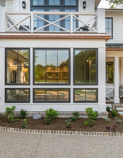 Sun room view of remodeled, energy-efficient luxury home near Asheville, North Carolina, featuring exposed beams and natural elements.