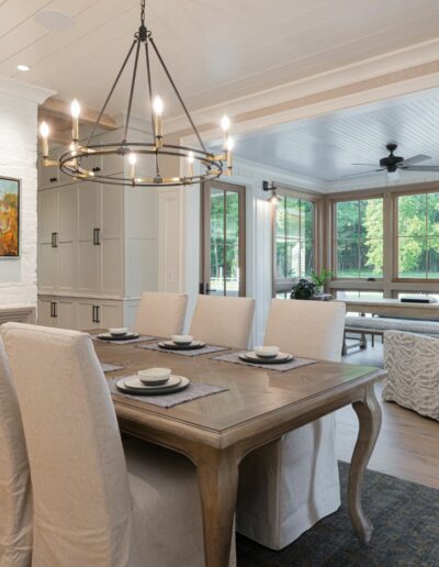 Remodeled dining room in energy-efficient luxury home near Asheville, North Carolina, featuring locally milled wood, exposed beams, and natural elements from original farmhouse.