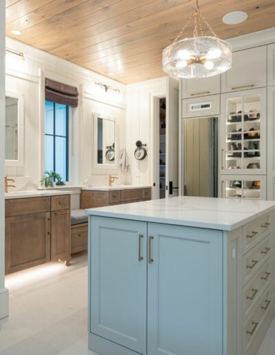 Huge walk-in master closet in a remodeled house with whole-home renovation, energy-efficient, luxury home builder near Asheville, North Carolina. Locally milled wood, exposed beams, and natural elements incorporated.