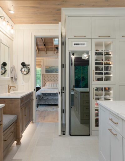 Huge walk-in master closet in a remodeled house with whole-home renovation, energy-efficient, luxury home builder near Asheville, North Carolina. Locally milled wood, exposed beams, and natural elements incorporated.