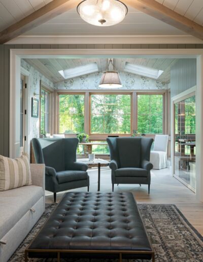 Remodeled living room and office in energy-efficient luxury home near Asheville, NC, featuring original farmhouse aspects, locally milled wood, exposed beams, and natural elements.