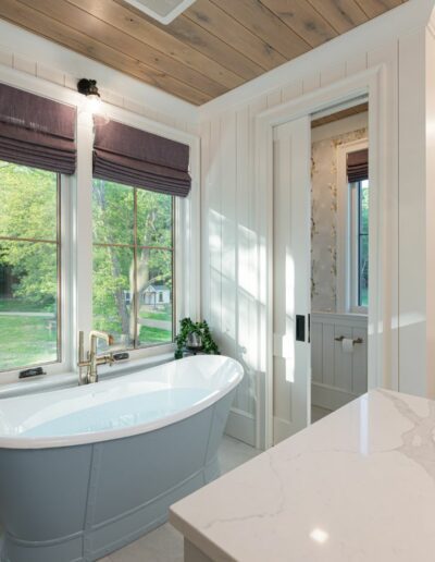Remodeled bathroom in energy-efficient luxury home near Asheville, North Carolina, with original farmhouse aspects, locally milled wood, exposed beams, and natural elements.