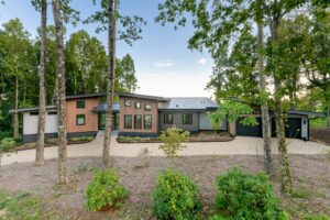 Front of the house surrounded by trees.