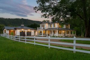 Remodeled energy-efficient luxury home near Asheville, North Carolina with original farmhouse aspects, locally milled wood, exposed beams, and natural elements, featured in 2023 Parade of Homes.