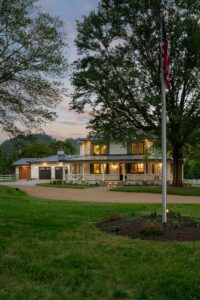 Remodeled house with whole-home renovation, energy-efficient, luxury home builder, near Asheville, North Carolina, incorporates original farmhouse aspects, locally milled wood, exposed beams, natural elements, featured in 2023 Parade of Homes.